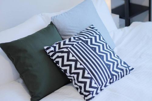 two pillows are sitting on a bed next to sidx sidx sidx at b hotel Ball Park - 2mins walk Baseball 5mins walk Hiroshima Sta in Hiroshima