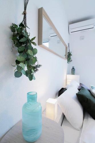 a blue vase sitting on a table in a living room at b hotel Ball Park - 2mins walk Baseball 5mins walk Hiroshima Sta 4ppl in Hiroshima