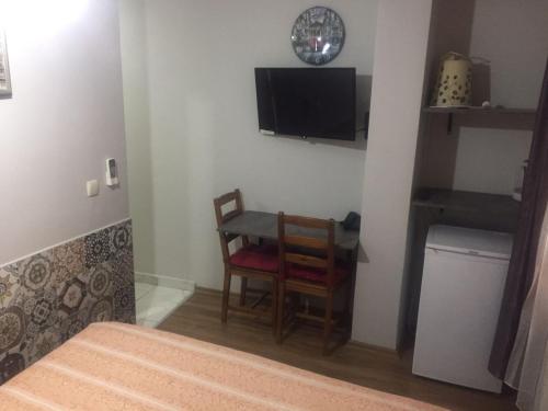 a room with a table and two chairs and a television at Galata Life Istanbul in Istanbul