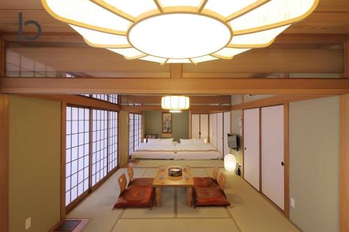 a large room with a large chandelier and a bedroom at Hanagin by b hotel - 3 Bedroom Japanese apartment for 11 people 201 in Hiroshima