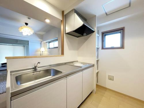a kitchen with a sink and a mirror at bHotel 560 Comfy Elegant 1BR apartment for 4 people in Hiroshima