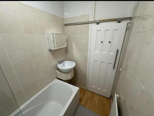 a bathroom with a toilet and a sink at Queenel Room in Eltham