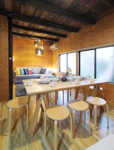 a dining room with a table and chairs at Nishikaniya by b hotel - Large Apartment 10mins walk from Hiroshima Station in Hiroshima