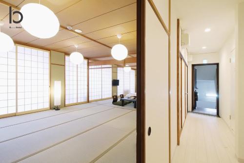 a hallway of an office building with windows and lights at Hanagin by b hotel - Large 2 bedroom apartment for 12people 301 in Hiroshima