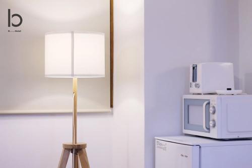 a lamp with a microwave on top of a refrigerator at bHOTEL Dai3Himawari - Japanese Apt 3mins walk PeacePark 6ppl in Hiroshima
