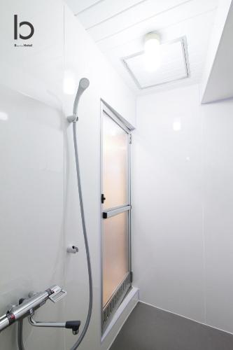 a shower in a bathroom with a mirror at bHOTEL Dai3Himawari - Japanese Apt 3mins walk PeacePark 6ppl in Hiroshima