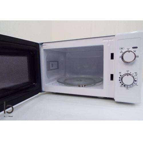 a microwave oven sitting on top of a counter at bHOTEL Dai3Himawari - Japanese Apt 3mins walk PeacePark 6ppl in Hiroshima