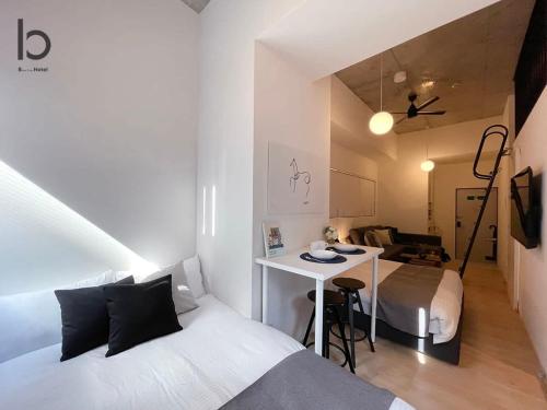 広島市にあるbHOTEL Nekoyard - 1 Bedroom with Loft Good For 7PPL Close To Peace Parkのベッド2台とデスクが備わる客室です。