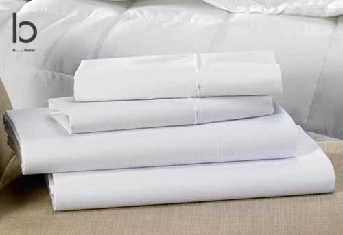 a stack of white pillows sitting on a bed at bHOTEL Nekoyard - Modern Loft Studio Near Peace Park & City Center in Hiroshima