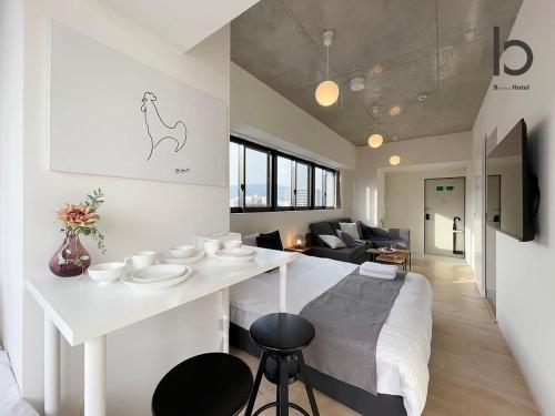 a kitchen and living room with a white counter top at b hotel Nekoyard - Studio with Security, Near Peace Park & Downtown in Hiroshima