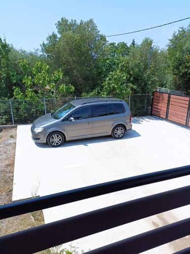 a silver van parked in a parking lot at Johnny 's private house in Néa Michanióna