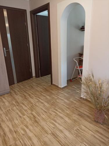 a room with a hallway with wooden floors and doors at Johnny 's private house in Néa Michanióna