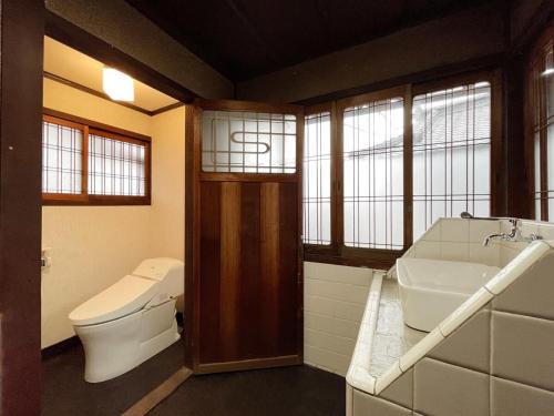 ein Bad mit einem WC und einem Waschbecken in der Unterkunft bLOCAL Hayase House - Vacation Villa facing ocean view with BBQ Grill Free Parking Space in Kure