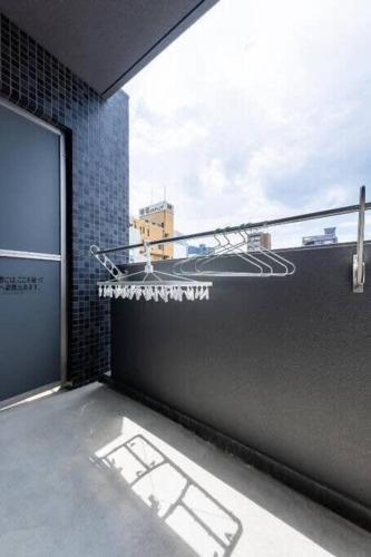 a room with a view of a building with a window at bHOTEL Nagomi - 1 BR Apt on the 9th flr with City view for 10 Ppl in Hiroshima