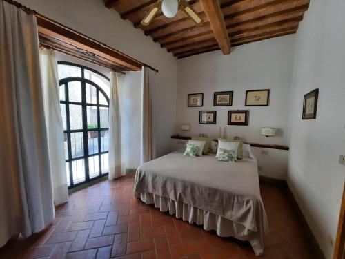 a bedroom with a bed and a large window at La Capanna,piscina,vista,WiFi,in paese in San Giovanni dʼAsso