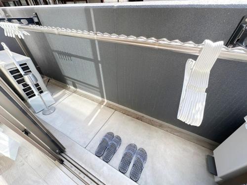 a row of blue shoes on the floor of a room at bHOTEL Yutori - Apt for 3 ppl Near Onomichi North Station in Onomichi