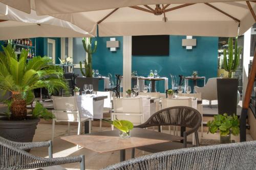un restaurante con mesas y sillas y una pared azul en The Guardian en Roma