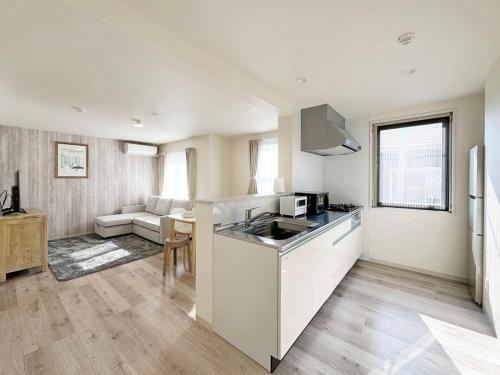a kitchen and living room with a counter top at Yutori by b hotel - Spacious 2BR Apartment very near the Station in Onomichi