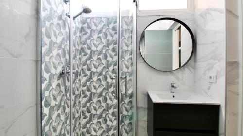 a bathroom with a shower with a sink and a mirror at Casa Simone - Luxury Sunny House in Caleta De Fuste