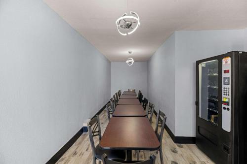 a row of tables and chairs in a room at Rodeway Inn Midland South in Midland