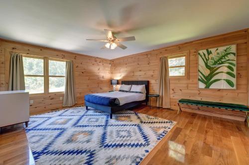 a bedroom with a bed and a ceiling fan at Berkshire Vacation Rentals: Great Barrington Cabin Sleeps 14 Walk To Town in Great Barrington