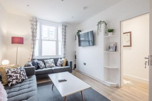 a living room with a couch and a table at Refurbished High Spec CENTRAL Family Home in Cambridge