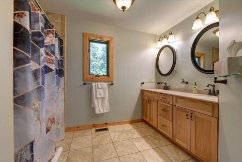 a bathroom with a sink and a mirror at Berkshire Vacation Rentals: Great Barrington Cabin Sleeps 14 Walk To Town in Great Barrington