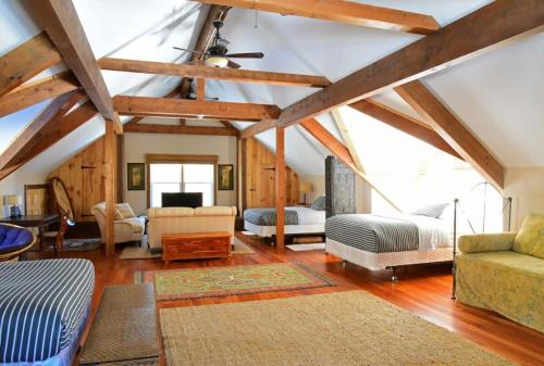 a large living room with a ceiling with wooden beams at Berkshire Vacation Rentals: Peaceful Post and Beam Loft Sleeps 9 in New Marlborough