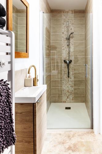 a bathroom with a shower and a sink at Espaces Gîtes in Sainte-Escobille
