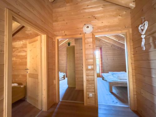 a log cabin with a bedroom and a bed at 1A Chalet Enzianhuette - im Wander und Skigebiet in Elsenbrunn
