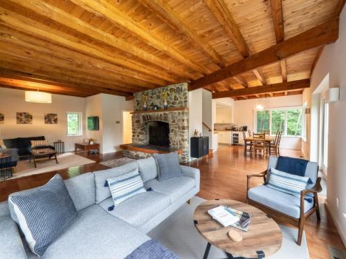a living room with a couch and a fireplace at Berkshire Vacation Rentals: High End Berkshires Getaway in East Hillsdale