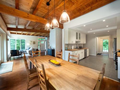 a kitchen and dining room with a wooden table and chairs at Berkshire Vacation Rentals: High End Berkshires Getaway in East Hillsdale