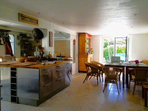 a kitchen with a table and a dining room at Villa aux roses in Roscoff