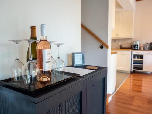 a table with wine bottles and glasses on it at Berkshire Vacation Rentals: High End Berkshires Getaway in East Hillsdale