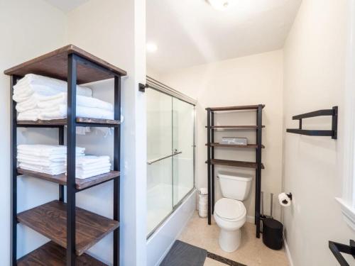 a bathroom with a toilet and a glass shower at Swampscott Retreat Four Bedrooms Come Unwind in Swampscott