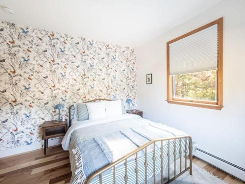 a bedroom with a bed with a floral wallpaper at Private Berkshires Home On 5+ Acres Rustic & Chic in Otis
