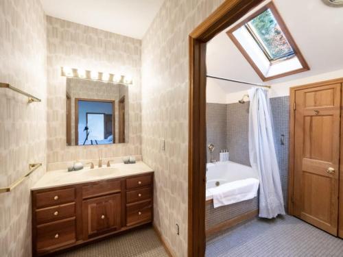 uma casa de banho com um lavatório e um espelho em Private Berkshires Home On 5+ Acres Rustic & Chic em Otis