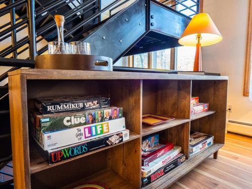 a book shelf filled with books next to a staircase at Private Berkshires Home On 5+ Acres Rustic & Chic in Otis