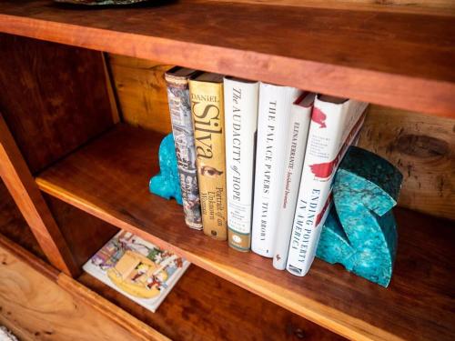 a book shelf with several books on it at Private Berkshires Home On 5+ Acres Rustic & Chic in Otis
