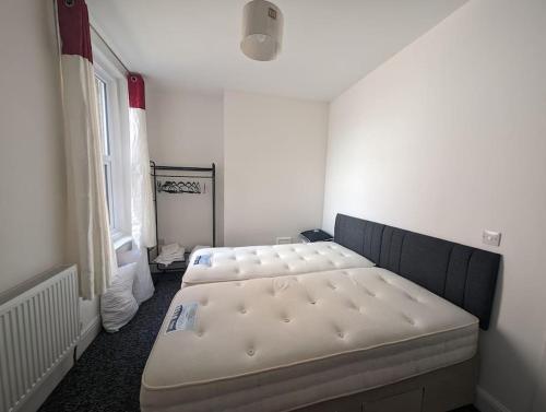 a bedroom with two beds in a room at Seaview House - Flat 2 in Lowestoft