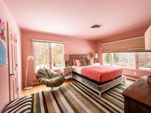 a bedroom with a bed and a large window at Berkshire Vacation Rentals: A+ Location: Easy Access To Downtown & Outdoors in Rhinebeck