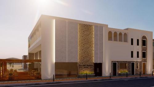 a large white building on the side of a street at Seaside Marmari in Marmari