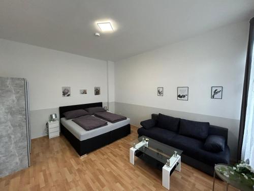 a living room with a bed and a couch at Paky Appartements 00210 in Vienna