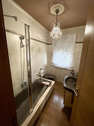 a bathroom with a shower and a sink and a tub at Casa Amelia Noia in Noya