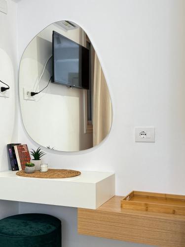 a living room with a mirror and a tv at Potami Seashell in Himare