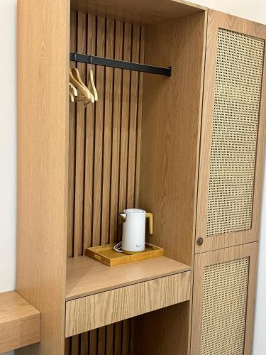 a cupboard with a mug on a wooden shelf at Potami Seashell in Himare