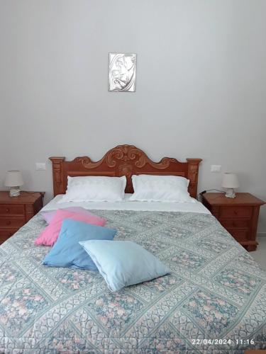 a bed with two pillows on top of it at La casa sul poggio in Lubriano