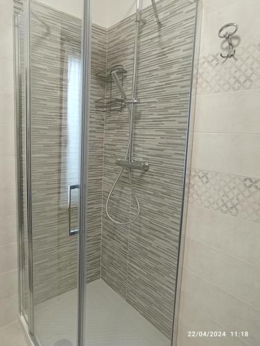 a shower with a glass door in a bathroom at La casa sul poggio in Lubriano