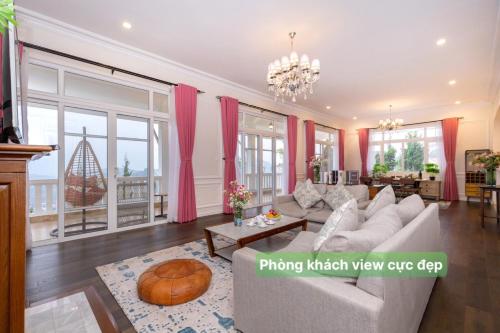 a living room with a couch and a table at Biệt Thự Đà Lạt View Đẹp - Gần Chợ Đêm in Xuan An