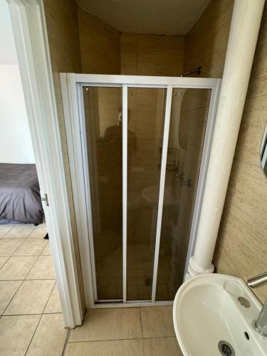 a glass shower in a bathroom with a sink at Ocean's 68 in Durban